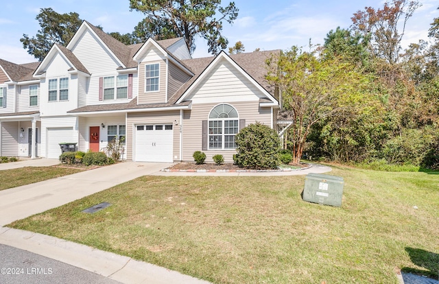 view of front of property with a garage and a front yard