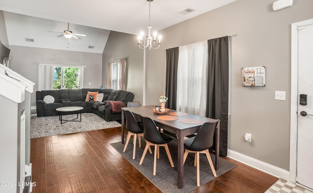 dining room featuring hardwood / wood-style flooring, lofted ceiling, and ceiling fan with notable chandelier