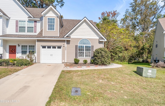 view of front of property with a garage and a front yard