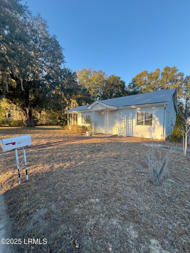 view of front of home with a porch and metal roof