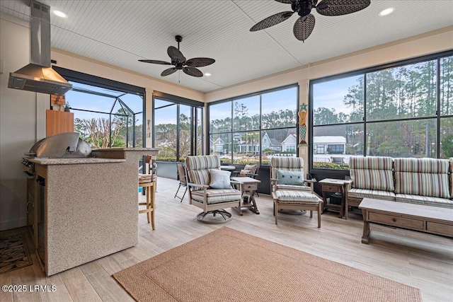 sunroom / solarium featuring ceiling fan and a healthy amount of sunlight