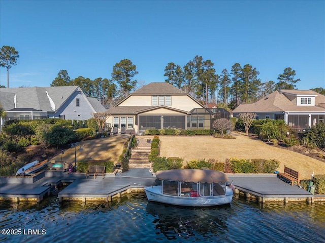 rear view of property featuring a water view and glass enclosure