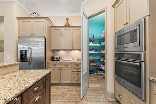 kitchen with backsplash, stainless steel appliances, ornamental molding, light hardwood / wood-style floors, and light stone countertops