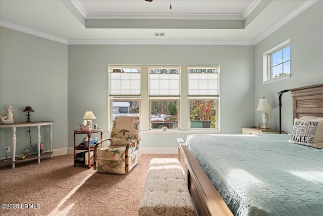 bedroom featuring ornamental molding, a raised ceiling, and carpet