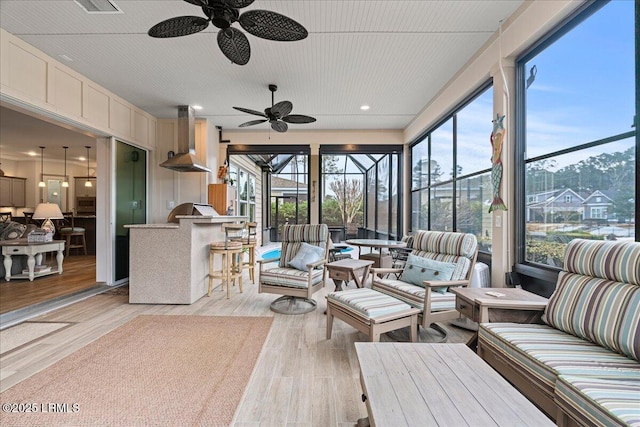 sunroom / solarium featuring ceiling fan