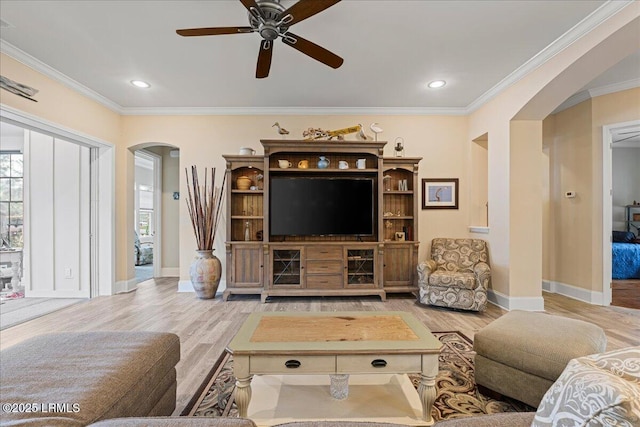 living room with crown molding, hardwood / wood-style flooring, and ceiling fan