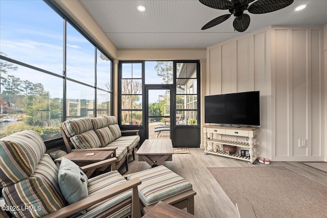 living room with light hardwood / wood-style floors and ceiling fan