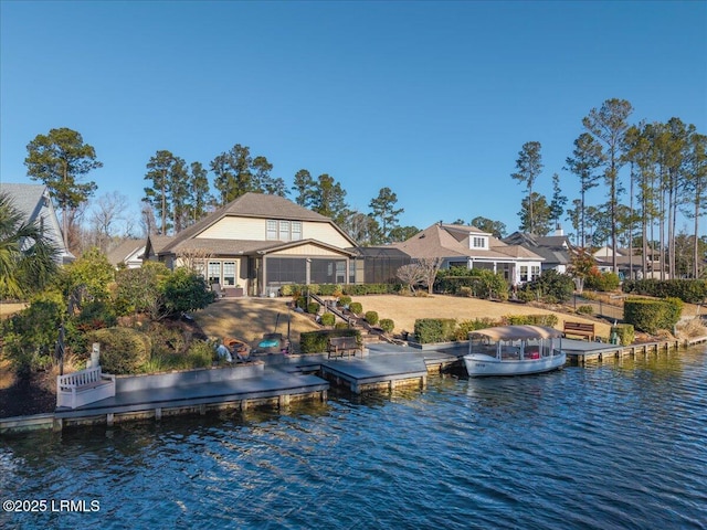 rear view of house featuring a water view