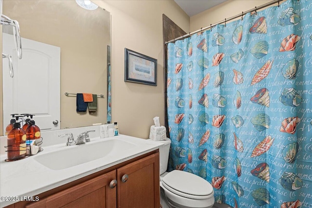 bathroom featuring vanity, a shower with curtain, and toilet