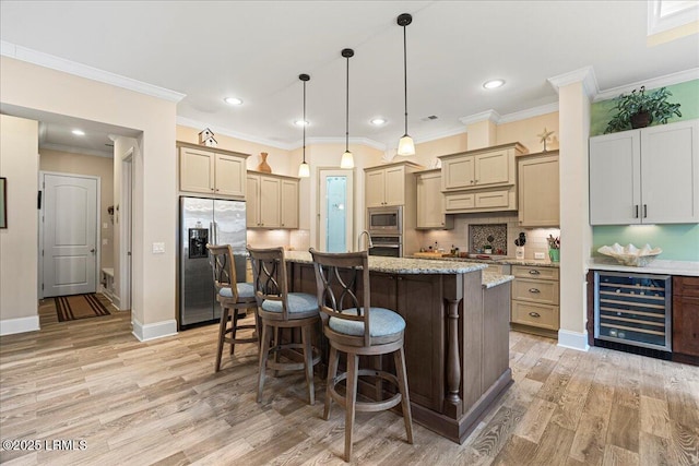 kitchen with wine cooler, stainless steel appliances, a kitchen island with sink, and decorative backsplash