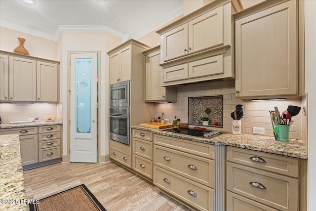 kitchen with backsplash, ornamental molding, light stone countertops, black electric cooktop, and light wood-type flooring