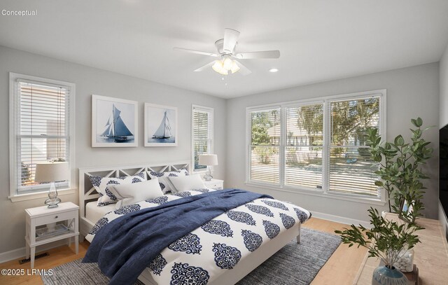 bedroom with visible vents, a ceiling fan, baseboards, and wood finished floors