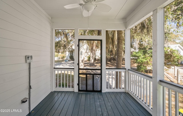 unfurnished sunroom featuring ceiling fan