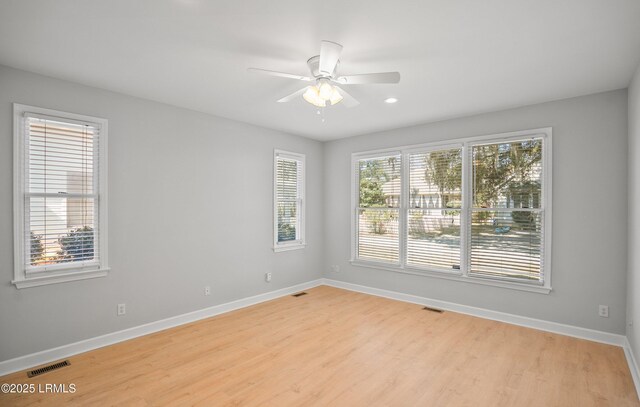 spare room featuring visible vents, baseboards, and a ceiling fan