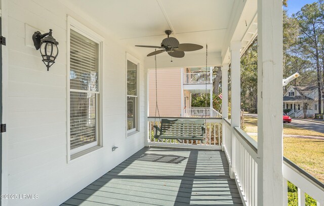 deck with a porch and ceiling fan