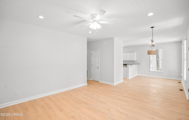 unfurnished living room with light wood-style flooring, recessed lighting, baseboards, and ceiling fan