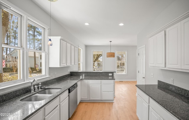 kitchen with light wood-style flooring, recessed lighting, a sink, white cabinets, and stainless steel dishwasher