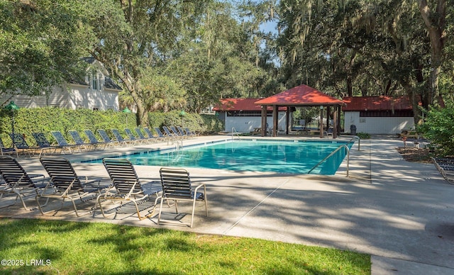 community pool with a gazebo and a patio