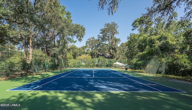 view of sport court featuring fence