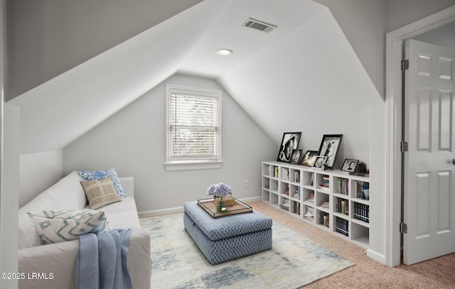 sitting room featuring visible vents, baseboards, carpet flooring, and vaulted ceiling