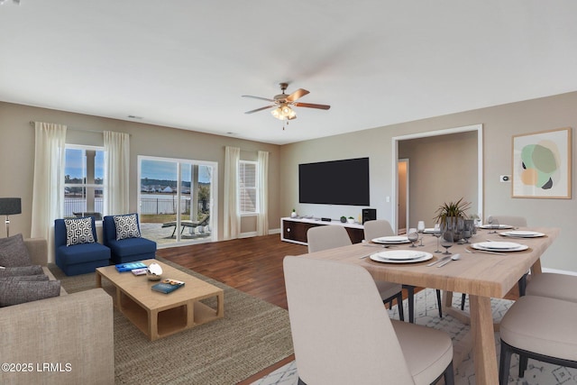 living area featuring baseboards, wood finished floors, and ceiling fan