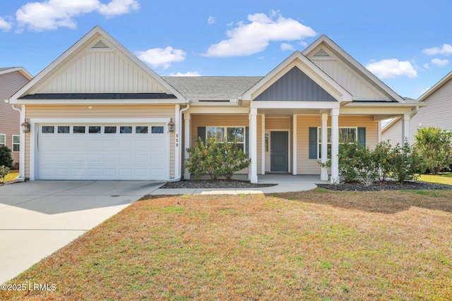 view of front of property featuring a porch, a garage, driveway, a front lawn, and board and batten siding