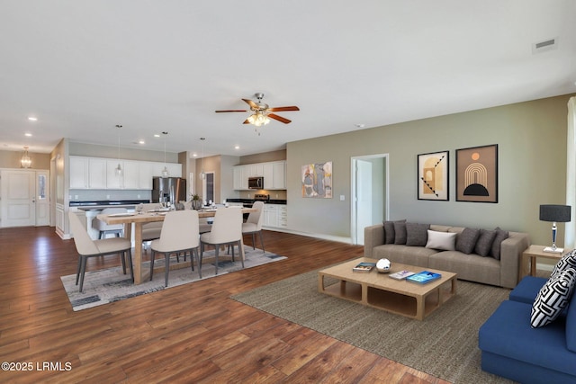 living room with visible vents, baseboards, ceiling fan, recessed lighting, and dark wood finished floors