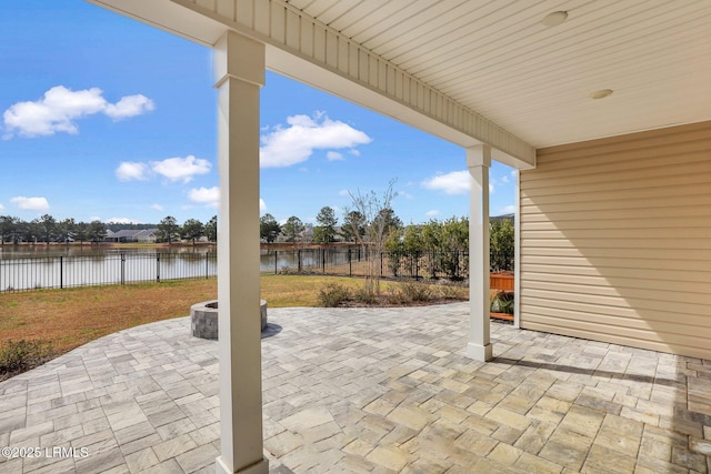 view of patio with a water view and a fenced backyard