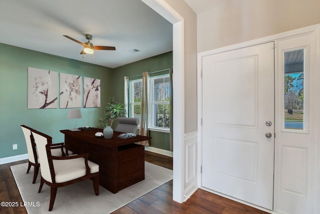 office featuring a ceiling fan, dark wood-type flooring, and baseboards