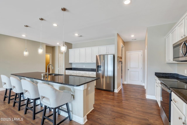 kitchen with white cabinetry, dark wood-style floors, a sink, and appliances with stainless steel finishes