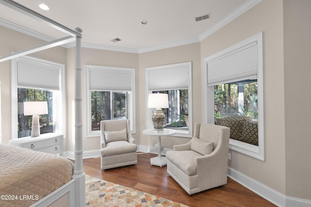 bedroom with decorative columns, ornamental molding, and dark hardwood / wood-style flooring