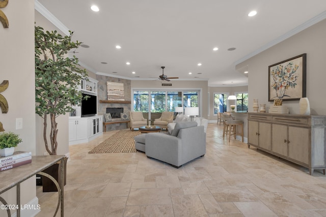 living room featuring a stone fireplace and ornamental molding