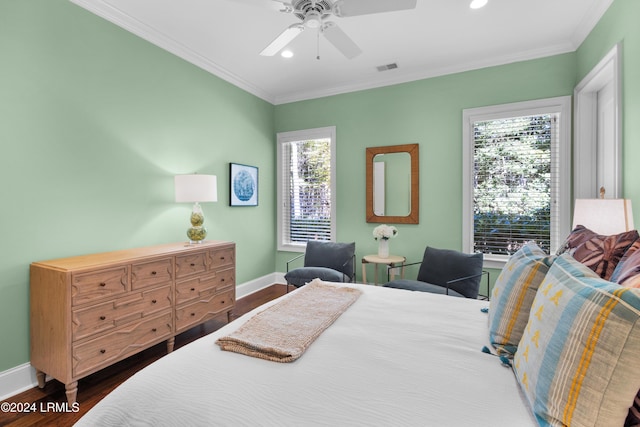 bedroom featuring ornamental molding, dark hardwood / wood-style floors, and ceiling fan