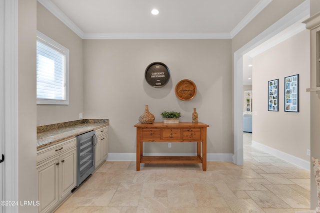 interior space featuring wine cooler, crown molding, and light stone countertops