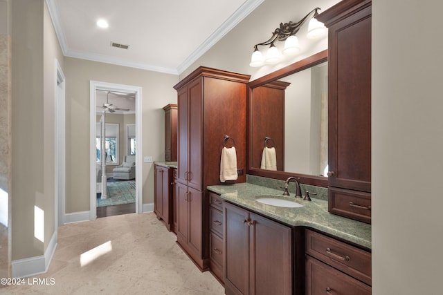 bathroom with ornamental molding and vanity