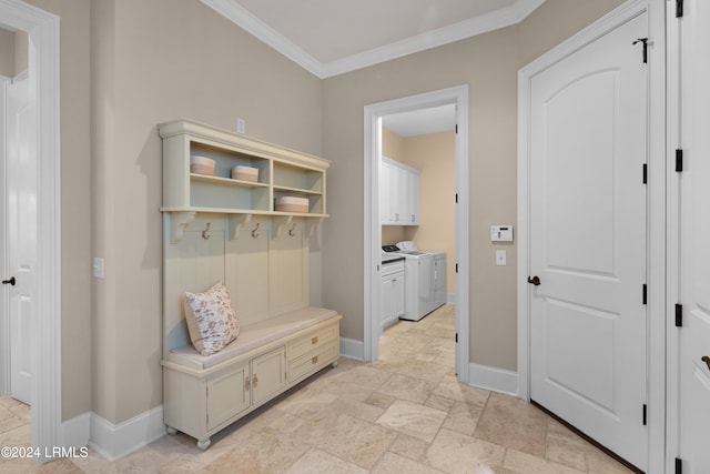 mudroom with ornamental molding and separate washer and dryer