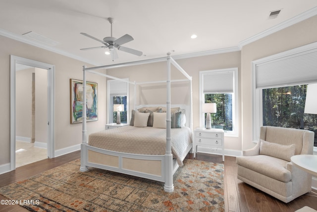 bedroom featuring dark wood-type flooring, ceiling fan, and crown molding