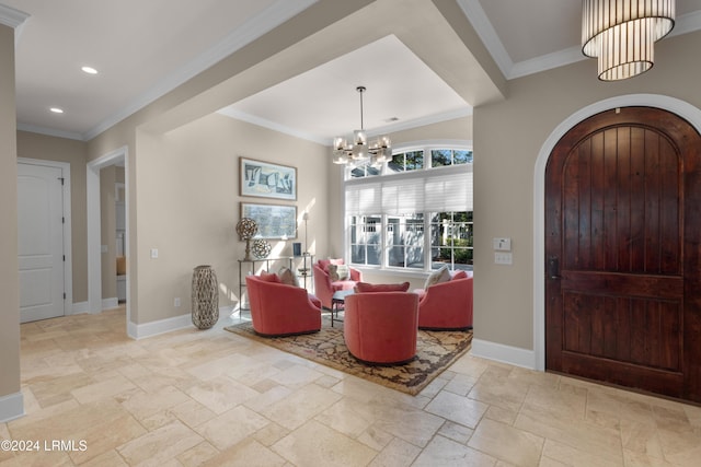 entryway featuring ornamental molding and a notable chandelier