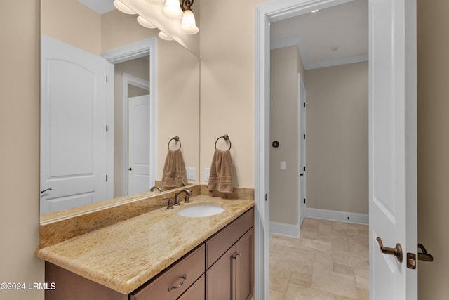 bathroom with vanity and ornamental molding