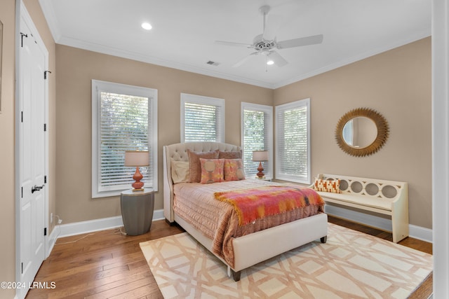 bedroom featuring crown molding, ceiling fan, and hardwood / wood-style floors