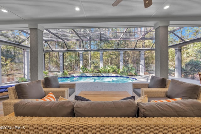 sunroom / solarium featuring ceiling fan