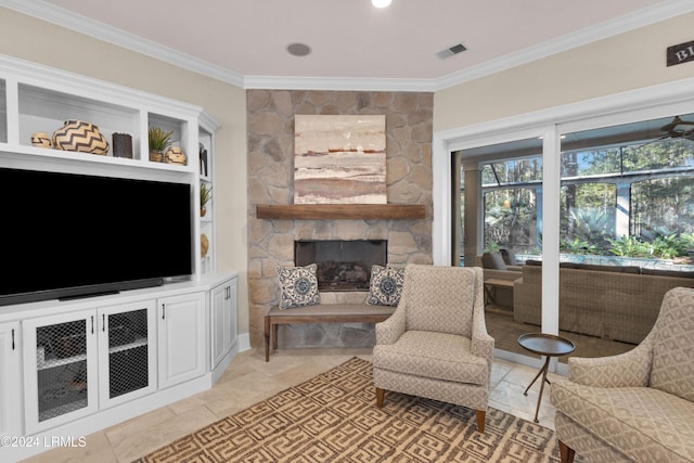 living room featuring ornamental molding, a stone fireplace, and built in features