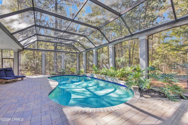 view of pool featuring a lanai and a patio