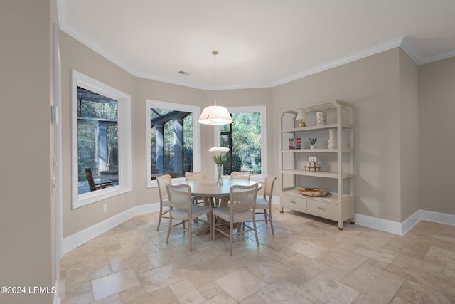 dining area featuring crown molding