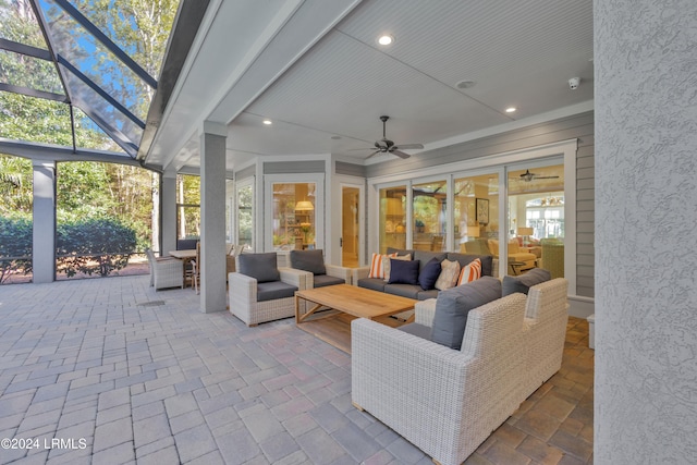 view of patio / terrace with an outdoor living space, a lanai, and ceiling fan