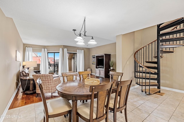 13 Harbourside Ln Unit 7170, Hilton Head Island, SC 29928 - dining area featuring light tile patterned flooring, stairs, baseboards, and a chandelier