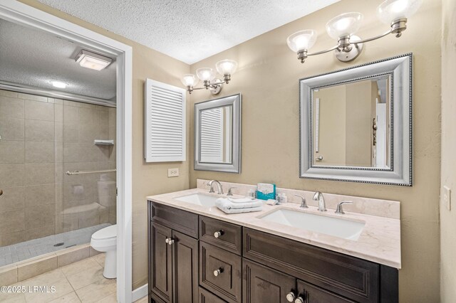 13 Harbourside Ln Unit 7170, Hilton Head Island, SC 29928 - bathroom featuring a textured ceiling, toilet, double vanity, a stall shower, and tile patterned flooring