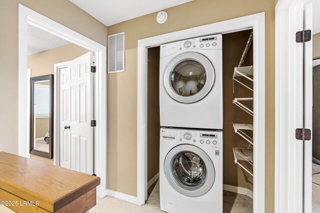 13 Harbourside Ln Unit 7170, Hilton Head Island, SC 29928 - washroom featuring stacked washer and clothes dryer and baseboards