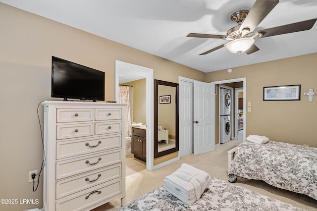 13 Harbourside Ln Unit 7170, Hilton Head Island, SC 29928 - bedroom with stacked washer / dryer, light colored carpet, connected bathroom, and ceiling fan