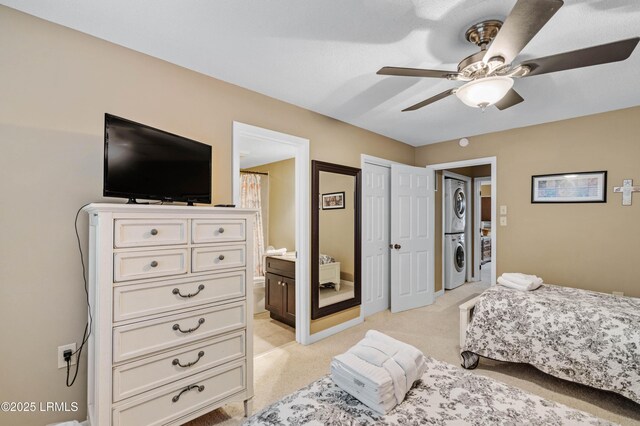 13 Harbourside Ln Unit 7170, Hilton Head Island, SC 29928 - bedroom with stacked washer / dryer, light colored carpet, connected bathroom, and ceiling fan